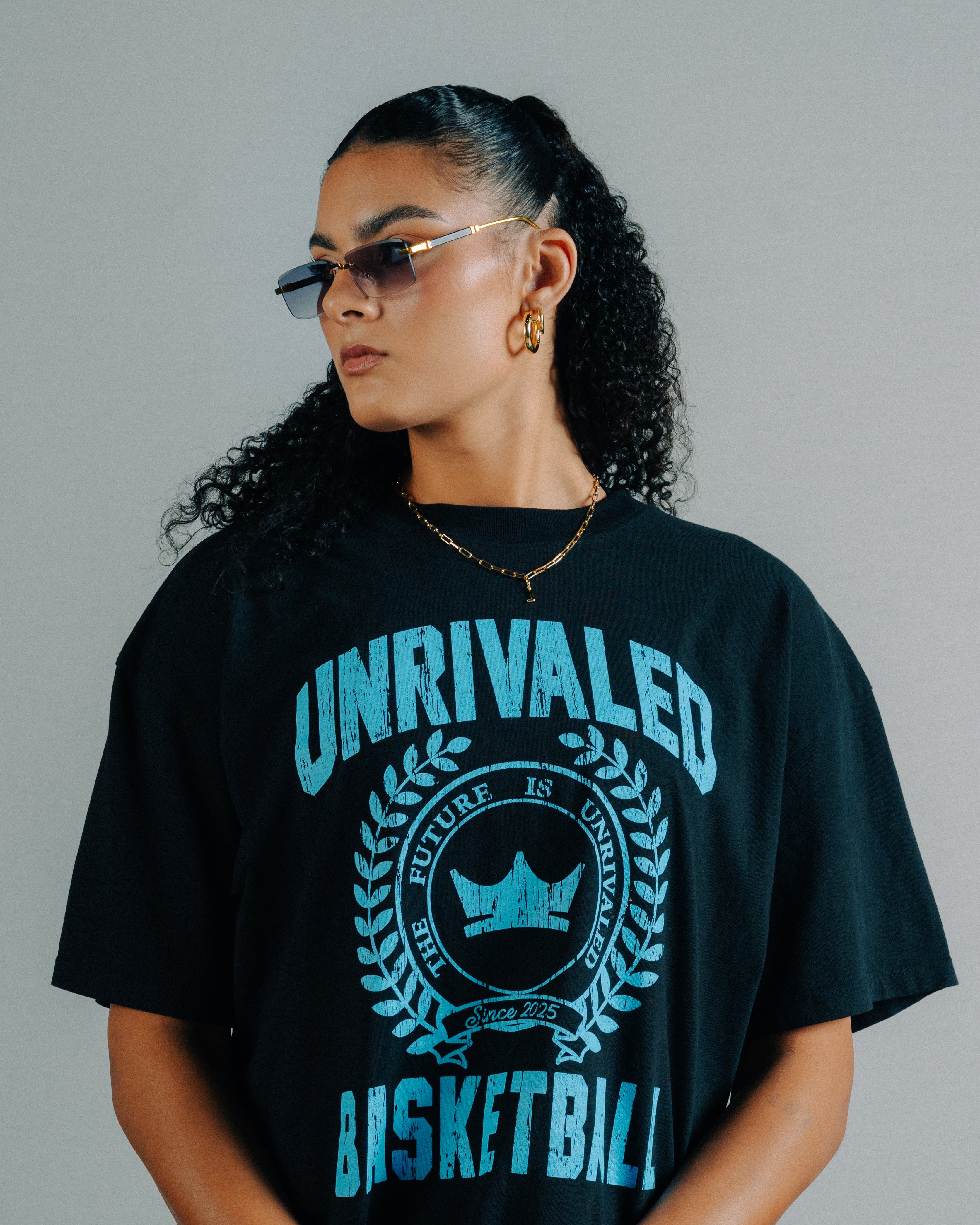 Lauren Betts wearing a black shirt with blue text that says Unrivaled Basketball 